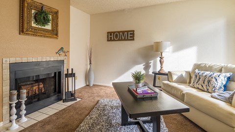 Ridgepointe living room with carpet flooring and nice cozy fireplace
